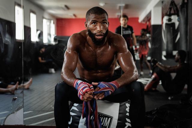 French-Moroccan mixed martial artist Salahdine Parnasse wraps his hands in protection gear during a training session at the Atch Academy training centre in Aubervilliers, a northern Paris suburb on August 13, 2026. For his UFC debut, Salahdine Parnasse is making a grand entrance as the headliner at UFC Paris – a "new beginning" in his career, according to the 28-year-old Frenchman, who is aiming to become the "ultimate fighter". (Photo by SIMON WOHLFAHRT / AFP)