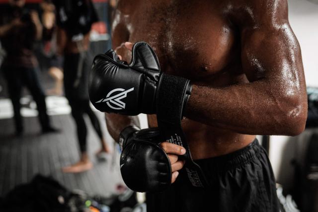 French-Moroccan mixed martial artist Salahdine Parnasse puts on gloves during a training session at the Atch Academy training centre in Aubervilliers, a northern Paris suburb on August 13, 2026. For his UFC debut, Salahdine Parnasse is making a grand entrance as the headliner at UFC Paris – a "new beginning" in his career, according to the 28-year-old Frenchman, who is aiming to become the "ultimate fighter". (Photo by SIMON WOHLFAHRT / AFP)