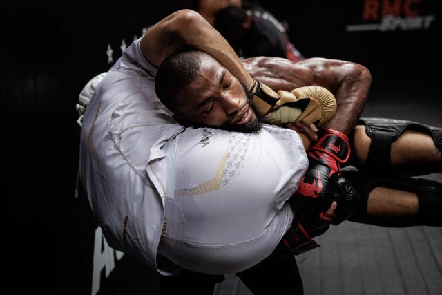 French-Moroccan mixed martial artist Salahdine Parnasse carries a training partner during a training session at the Atch Academy training centre in Aubervilliers, a northern Paris suburb on August 13, 2026. For his UFC debut, Salahdine Parnasse is making a grand entrance as the headliner at UFC Paris – a "new beginning" in his career, according to the 28-year-old Frenchman, who is aiming to become the "ultimate fighter". (Photo by SIMON WOHLFAHRT / AFP)