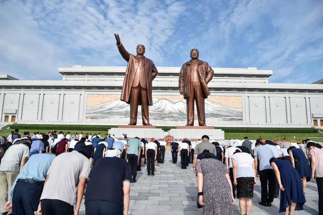 People pay their respect before the statues of late North Korean leaders Kim Il Sung and Kim Jong Il on Mansu Hill in Pyongyang on August 15, 2026, as North Korea marks its 81st National Liberation Day commemorating the end of Japanese colonial rule at the end of World War II. (Photo by KIM Won Jin / AFP)