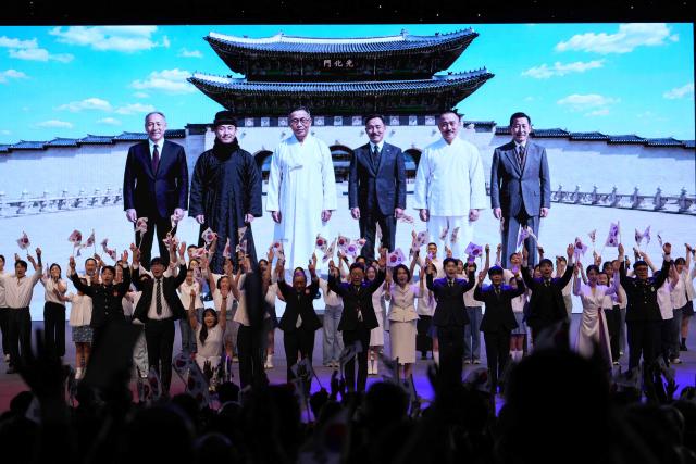 South Korean President Lee Jae Myung (C) and his wife Kim Hea Kyung (centre R) wave the national flags during a ceremony to celebrate the 81st anniversary of the Korean Liberation Day in Seoul on August 15, 2026. (Photo by Lee Jin-man / POOL / AFP)