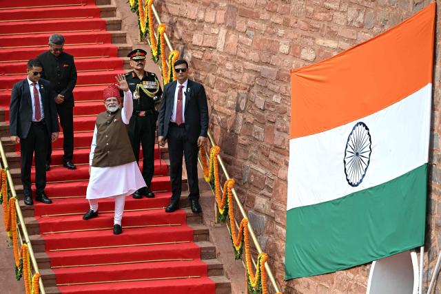 India's Prime Minister Narendra Modi (C) leaves after addressing the nation from the ramparts of the Red Fort during the celebrations to mark the country's Independence Day in New Delhi on August 15, 2026. (Photo by Sajjad HUSSAIN / AFP)