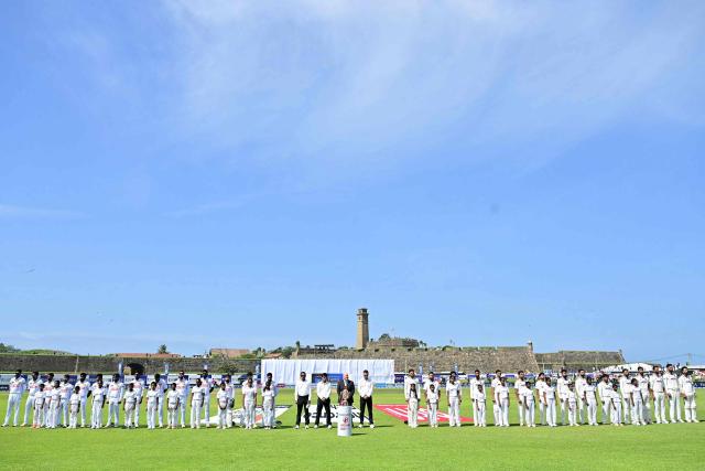 Sri Lankan (L) and Indian (R) cricket players line-up for the national anthems to be played before start of play on the first day of the first Test cricket match between Sri Lanka and India at the Galle International Stadium in Galle on August 15, 2026. (Photo by Ishara S. KODIKARA / AFP)
