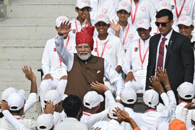 India's Prime Minister Narendra Modi (C) waves to the members of National Cadet Corps (NCC) after addressing the nation at the Red Fort during the celebrations to mark country's Independence Day in New Delhi on August 15, 2026. (Photo by Sajjad HUSSAIN / AFP)