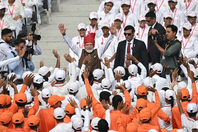 India's Prime Minister Narendra Modi (C) waves to the members of National Cadet Corps (NCC) after addressing the nation at the Red Fort during the celebrations to mark country's Independence Day in New Delhi on August 15, 2026. (Photo by Sajjad HUSSAIN / AFP)