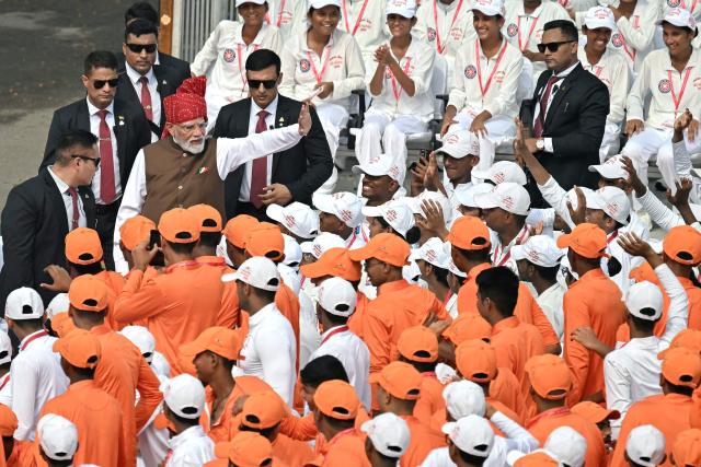India's Prime Minister Narendra Modi (2L) waves to the members of National Cadet Corps (NCC) after addressing the nation at the Red Fort during the celebrations to mark country's Independence Day in New Delhi on August 15, 2026. (Photo by Sajjad HUSSAIN / AFP)