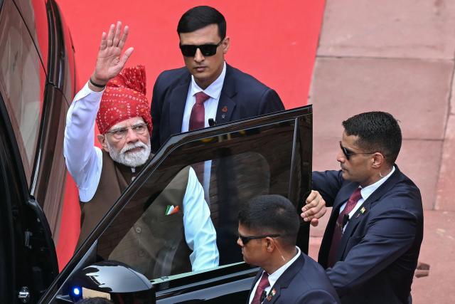 India's Prime Minister Narendra Modi (L) leaves after addressing the nation from the ramparts of the Red Fort during the celebrations to mark the country's Independence Day in New Delhi on August 15, 2026. (Photo by Sajjad HUSSAIN / AFP)