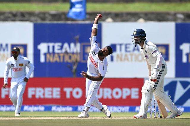 Sri Lanka's Lahiru Kumara (C) delivers a ball as India's KL Rahul (R) looks on during the first day of the first Test cricket match between Sri Lanka and India at the Galle International Stadium in Galle on August 15, 2026. (Photo by Ishara S. KODIKARA / AFP)