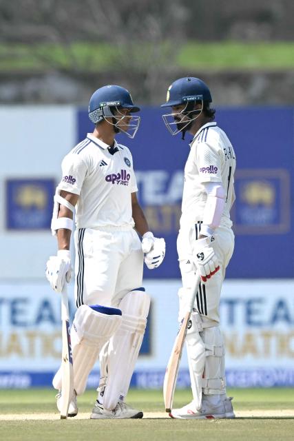 India's KL Rahul (R) talks with teammate Yashasvi Jaiswal (L) during the first day of the first Test cricket match between Sri Lanka and India at the Galle International Stadium in Galle on August 15, 2026. (Photo by Ishara S. KODIKARA / AFP)