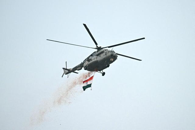An Indian Air Force (IAF) helicopter showers flower petals during the celebrations to mark the country's Independence Day at the Red Fort in New Delhi on August 15, 2026. (Photo by Sajjad HUSSAIN / AFP)