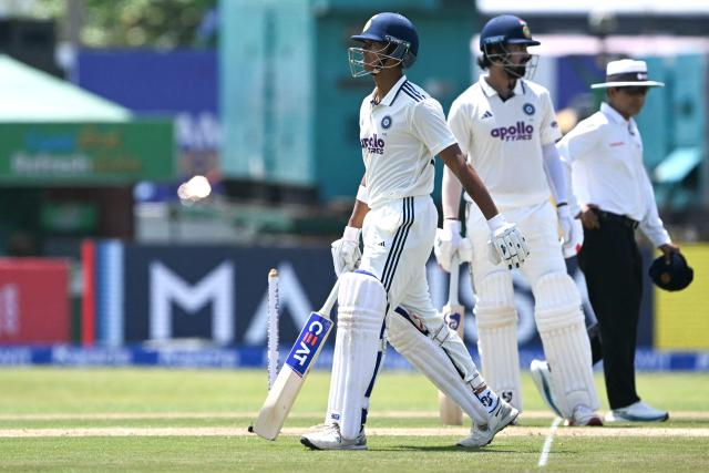 India's Yashasvi Jaiswal (L) walks back to pavilion after his dismissal during the first day of the first Test cricket match between Sri Lanka and India at the Galle International Stadium in Galle on August 15, 2026. (Photo by Ishara S. KODIKARA / AFP)