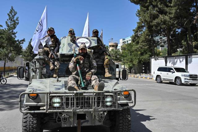 Taliban security personnel take part in a parade in front of the former US Embassy building in Kabul on August 15, 2026 as they celebrate the fifth anniversary of the Taliban government's return to power. The Taliban government celebrates five years of ruling Afghanistan on August 15, with the authorities hailing their country's "freedom" and security, while critics decry tightening restrictions in all areas of daily life. (Photo by Wakil Kohsar / AFP)
