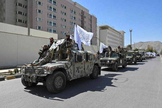 A convoy of Taliban security personnel take part in a parade in front of the former US Embassy building in Kabul on August 15, 2026 as they celebrate the fifth anniversary of the Taliban government's return to power. The Taliban government celebrates five years of ruling Afghanistan on August 15, with the authorities hailing their country's "freedom" and security, while critics decry tightening restrictions in all areas of daily life. (Photo by Wakil KOHSAR / AFP)