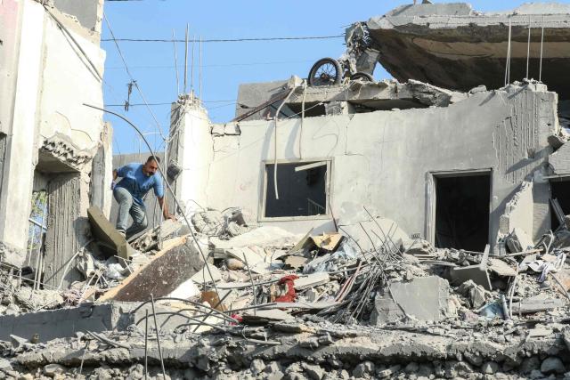A man searches for survivors amidst the rubble on the aftermath of an Israeli airstrike that targeted a house in the southern Lebanese village of Ansar on August 15, 2026. Lebanese state media said an Israeli strike in the country's south on August 15, killed seven people and wounded three others, the worst toll since deals in June saw a lull in hostilities between Israel and Hezbollah. Hezbollah drew Lebanon into the Middle East war in March with rocket fire at Israel in support of its backer Iran. Israel responded with heavy airstrikes and a ground invasion that Lebanese authorities say have killed more than 4,300 people. (Photo by Mahmoud ZAYYAT / AFP)