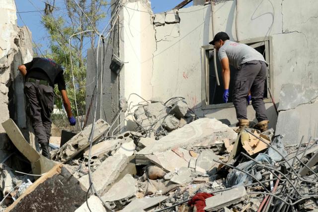 First responders search for survivors amidst the rubble following the aftermath of an airstrike by Israel that targeted a house in the southern Lebanese village of Ansar on August 15, 2026. Lebanese state media said an Israeli strike in the country's south on August 15, killed seven people and wounded three others, the worst toll since deals in June saw a lull in hostilities between Israel and Hezbollah. Hezbollah drew Lebanon into the Middle East war in March with rocket fire at Israel in support of its backer Iran. Israel responded with heavy airstrikes and a ground invasion that Lebanese authorities say have killed more than 4,300 people. (Photo by Mahmoud ZAYYAT / AFP)