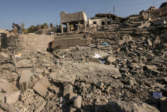 A man walks on the rubble of destroyed buildings, the aftermath of an Israeli airstrike that targeted a house in the southern Lebanese village of Ansar on August 15, 2026. Lebanese state media said an Israeli strike in the country's south on August 15, killed seven people and wounded three others, the worst toll since deals in June saw a lull in hostilities between Israel and Hezbollah. Hezbollah drew Lebanon into the Middle East war in March with rocket fire at Israel in support of its backer Iran. Israel responded with heavy airstrikes and a ground invasion that Lebanese authorities say have killed more than 4,300 people. (Photo by MAHMOUD ZAYYAT / AFP)