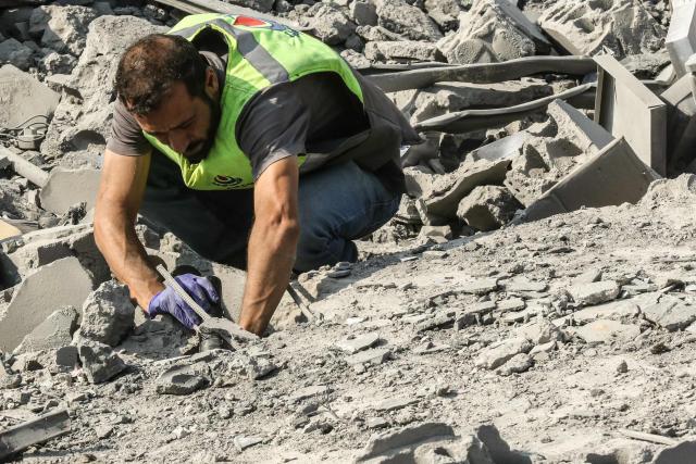 A first responder searches for victims amidst the rubble on the aftermath of an Israeli airstrike that targeted a house in the southern Lebanese village of Ansar on August 15, 2026. Lebanese state media said an Israeli strike in the country's south on August 15, killed seven people and wounded three others, the worst toll since deals in June saw a lull in hostilities between Israel and Hezbollah. Hezbollah drew Lebanon into the Middle East war in March with rocket fire at Israel in support of its backer Iran. Israel responded with heavy airstrikes and a ground invasion that Lebanese authorities say have killed more than 4,300 people. (Photo by Mahmoud ZAYYAT / AFP)