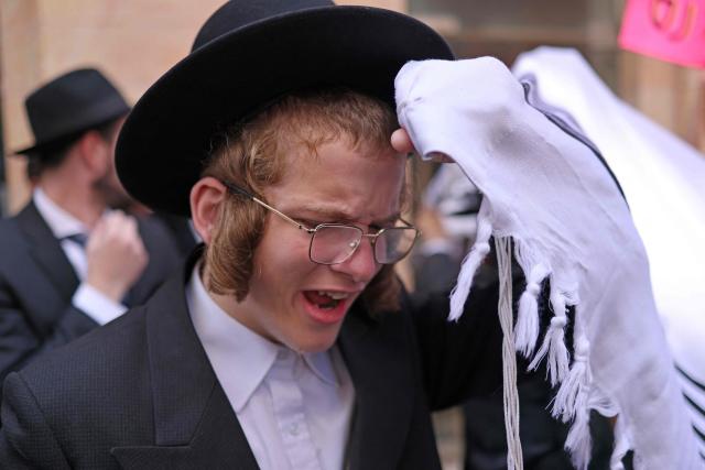 Ultra-Orthodox protesters demonstrate against Cafe Basimta operating on Shabbat, the weekly Jewish day of rest, as secular activists stage a counter-protest in support of the cafe, in central Jerusalem, on August 15, 2026. (Photo by AHMAD GHARABLI / AFP)