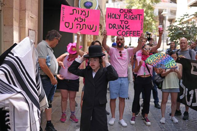 Ultra-Orthodox protesters demonstrate against Cafe Basimta operating on Shabbat, the weekly Jewish day of rest, as secular activists stage a counter-protest in support of the cafe, in central Jerusalem, on August 15, 2026. (Photo by AHMAD GHARABLI / AFP)