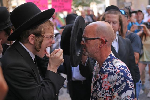 Ultra-Orthodox protesters demonstrate against Cafe Basimta operating on Shabbat, the weekly Jewish day of rest, as secular activists stage a counter-protest in support of the cafe, in central Jerusalem, on August 15, 2026. (Photo by AHMAD GHARABLI / AFP)