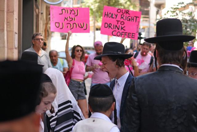 Ultra-Orthodox protesters demonstrate against Cafe Basimta operating on Shabbat, the weekly Jewish day of rest, as secular activists stage a counter-protest in support of the cafe, in central Jerusalem, on August 15, 2026. (Photo by AHMAD GHARABLI / AFP)