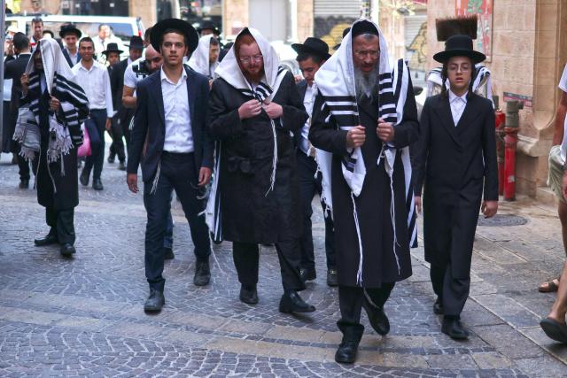 Ultra-Orthodox protesters demonstrate against Cafe Basimta operating on Shabbat, the weekly Jewish day of rest, as secular activists stage a counter-protest in support of the cafe, in central Jerusalem, on August 15, 2026. (Photo by AHMAD GHARABLI / AFP)