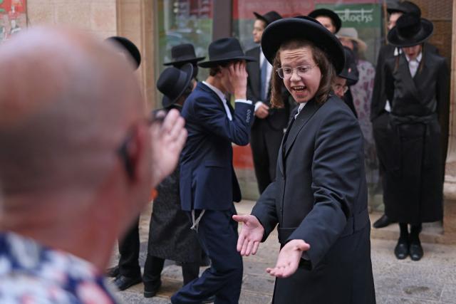 Ultra-Orthodox protesters demonstrate against Cafe Basimta operating on Shabbat, the weekly Jewish day of rest, as secular activists stage a counter-protest in support of the cafe, in central Jerusalem, on August 15, 2026. (Photo by AHMAD GHARABLI / AFP)