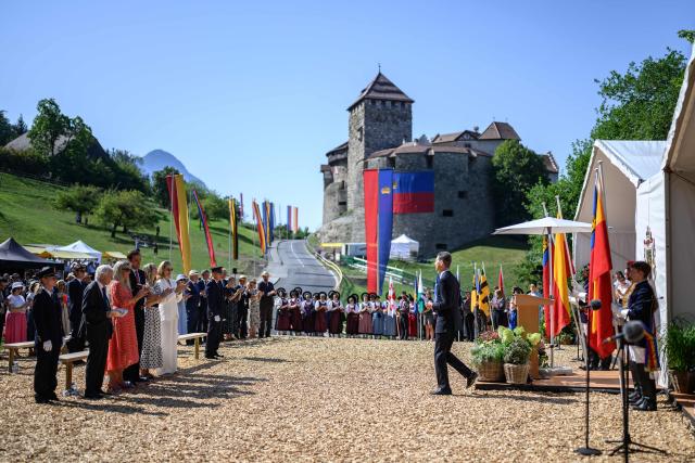 Liechtenstein's Hereditary Prince Alois (C) walks after delivering a speech on with the Vaduz Castle as background during Liechtenstein's National Day celebrations in Vaduz, on August 15, 2026. Each year on National Day, members of the Princely Family join thousands of residents and visitors for official ceremonies and public celebrations. (Photo by Fabrice COFFRINI / AFP)