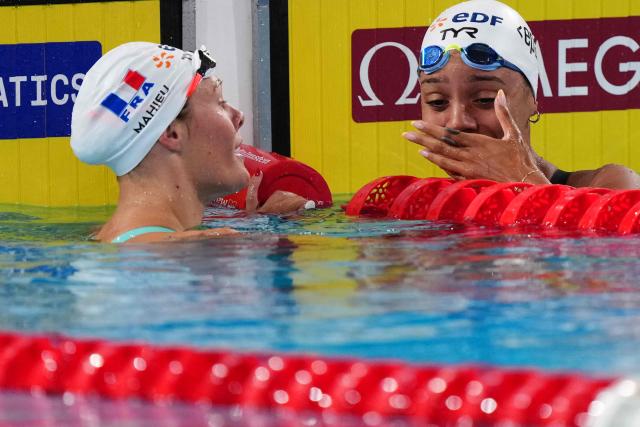 France's Mary-Ambre Moluh (R) celebrates her victory with France's Pauline Mahieu (runner-up) at the end of the final of the women's 100m backstroke swimming event during the LEN European Aquatics Championships at the Olympic Aquatic Centre in Saint-Denis, northern suburbs of Paris, on August 15, 2026. (Photo by Dimitar DILKOFF / AFP)