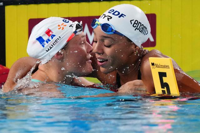 France's Mary-Ambre Moluh (R) celebrates her victory with France's Pauline Mahieu (runner-up) at the end of the final of the women's 100m backstroke swimming event during the LEN European Aquatics Championships at the Olympic Aquatic Centre in Saint-Denis, northern suburbs of Paris, on August 15, 2026. (Photo by Dimitar DILKOFF / AFP)