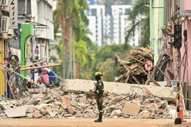 A rescuer stands in a street full of debris in Pereira, Colombia, on August 15, 2026, days after a 7.4 earthquake. At least 287 people have died, thousands have been injured and about 379 remain unaccounted for, while the chances of finding earthquake survivors have dropped sharply since the critical 72-hour window passed. (Photo by Luis ACOSTA / AFP)
