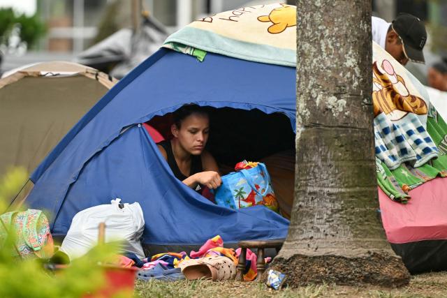 A woman sits inside a tent at an improvised camp in Pereira, Colombia, on August 15, 2026, days after a 7.4 earthquake. At least 287 people have died, thousands have been injured and about 379 remain unaccounted for, while the chances of finding earthquake survivors have dropped sharply since the critical 72-hour window passed. (Photo by Luis ACOSTA / AFP)