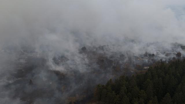 This aerial photograph shows a wildfire burning in the Hautes Fagnes (High Fens) nature reserve in Waimes on August 15, 2026. Residents began evacuating from two villages in eastern Belgium on August 15, 2026 as firefighters, backed by water bombers and helicopters from across Europe, battled one of the biggest wildfires in the country's history. Reinforcements from across the country were fighting the blaze which broke out on August 14, 2026 in the High Fens (Hautes Fagnes) natural park and quickly expanded burning an estimated 1600 hectares of the 4500 hectare reserve. (Photo by Dimitri KORCZAK / AFP)