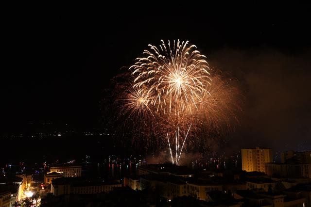 This photograph shows the firework during celebrations for the Assumption Day over the city of Ajaccio on the French Mediterranean island of Corsica on August 15, 2026. (Photo by Pascal POCHARD-CASABIANCA / AFP)