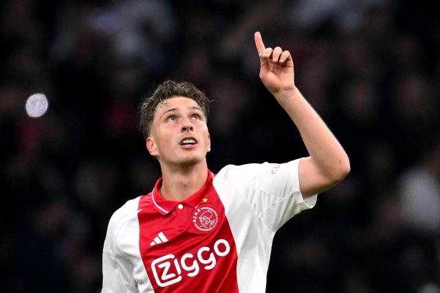(FILES) Ajax's Belgian forward #11 Mika Godts celebrates scoring his team' second goal during the UEFA Europa League football match between Ajax Amsterdam and Besiktas at The Johan Cruijff Arena Stadium in Amsterdam on September 26, 2024. Paris Saint-Germain officially announced on August 15, 2026 the signing of Belgian left-winger Mika Godts from Ajax Amsterdam on a contract running until 2031. (Photo by JOHN THYS / AFP)