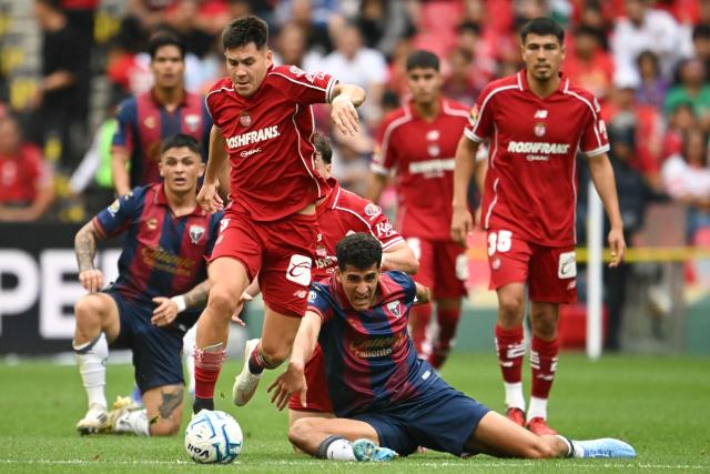 Toluca's Argentine forward #05 Franco Romero (L) and Atlante's defender #06 Nico Carrera fight for the ball during the Liga MX Apertura tournament football match between Atlante and Toluca at Banorte stadium in Mexico City on August 15, 2026. (Photo by CARL DE SOUZA / AFP)