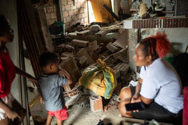 People remain amid the ruins of a house in the Medrano neighborhood of Quibdo, Choco department, Colombia, on August 15, 2026, days after a 7.4- magnitude earthquake. At least 287 people have died, thousands have been injured and about 379 remain unaccounted for, as the chances of finding earthquake survivors have dropped sharply since the critical 72-hour window passed, though volunteers and rescue crews continue digging through the rubble for any signs of life. (Photo by ESTEBAN VEGA LA-ROTTA / AFP)