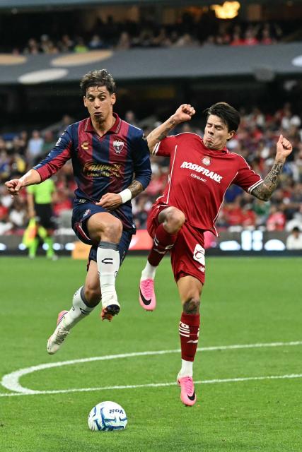 Atlante's Argentine midfielder #30 Martin Sarrafiore and Toluca's forward #15 Pavel Perez fight for the ball during the Liga MX Apertura tournament football match between Atlante and Toluca at Banorte stadium in Mexico City on August 15, 2026. (Photo by CARL DE SOUZA / AFP)