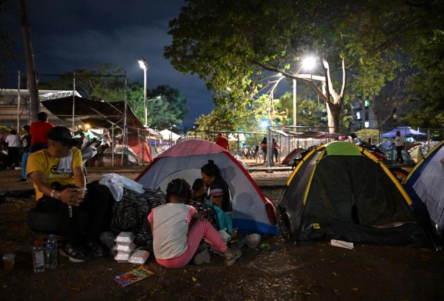 People spend the night on tents in a makeshift camp after a 7.4 earthquake in Cali, Colombia on August 15, 2026. At least 287 people have died, thousands have been injured and about 379 remain unaccounted for, as the chances of finding earthquake survivors have dropped sharply since the critical 72-hour window passed, though volunteers and rescue crews continue digging through the rubble for any signs of life. (Photo by Raul ARBOLEDA / AFP)
