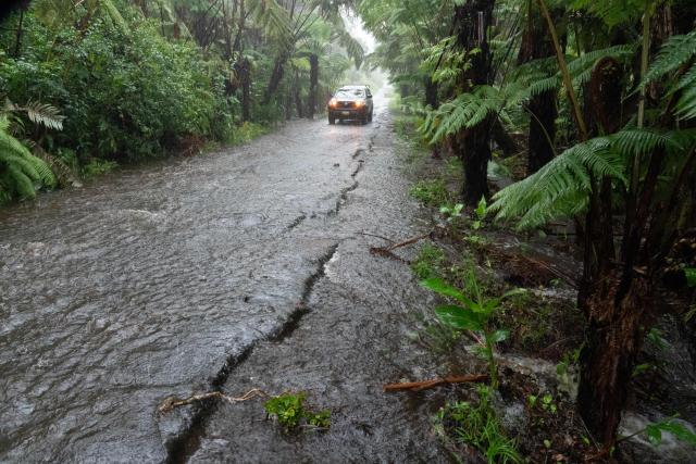A rural road floods in Volcano Village at 4000' elevation on Hawaii Island, on August 15, 2026. Hurricane Lala on Saturday lashed Hawaii's Big Island with heavy rain and strong winds, as forecasters warned of potentially dangerous flooding across the US Pacific island state.
Lala strengthened into a Category 1 hurricane at around 9:00 am local time (1900 GMT), generating winds of up to 75 miles per hour (120 kilometers per hour). (Photo by Jill K. Briggs / AFP)