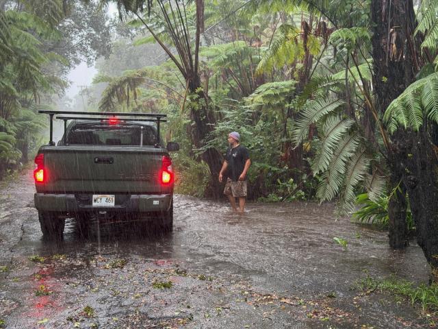A resident stops on a rural road as it floods in Volcano Village on Hawaii Island, on August 15, 2026. Hurricane Lala on Saturday lashed Hawaii's Big Island with heavy rain and strong winds, as forecasters warned of potentially dangerous flooding across the US Pacific island state.
Lala strengthened into a Category 1 hurricane at around 9:00 am local time (1900 GMT), generating winds of up to 75 miles per hour (120 kilometers per hour). (Photo by Jill K. Briggs / AFP)