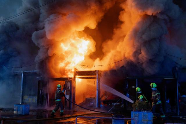 Ukrainian rescuers work at the site of a Russian strike in Kyiv on August 16, 2026, amid the Russian invasion of Ukraine. Russian strikes killed one person and wounded at least seven others in Ukraine, authorities said August 16, while Moscow officials reported downing more than 100 drones heading towards the capital. (Photo by Tetiana DZHAFAROVA / AFP)