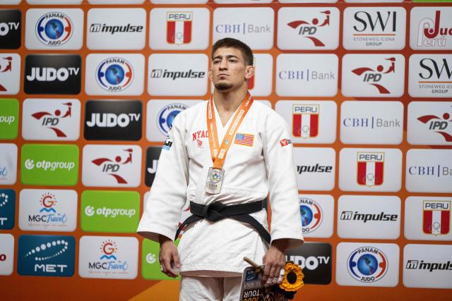 US Jack Yonezuka poses with his silver medal after the men's -73kg category final event, during the International Judo Federation (IJF) Lima Grand Prix 2026, in Lima, on August 15, 2026. (Photo by ERNESTO BENAVIDES / AFP)