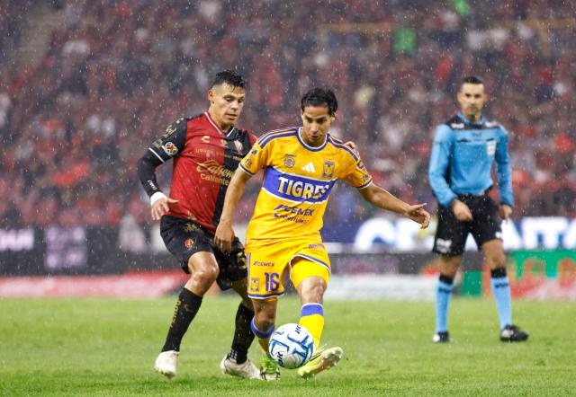 Atlas' forward #58 Arturo Gonzalez and Tigres' midfielder #16 Diego Lainez fight for the ball during the Liga MX Apertura tournament football match between Atlas and Tigres at Jalisco stadium in Guadalajara, state of Jalisco, Mexico on August 15, 2026. (Photo by ULISES RUIZ / AFP)