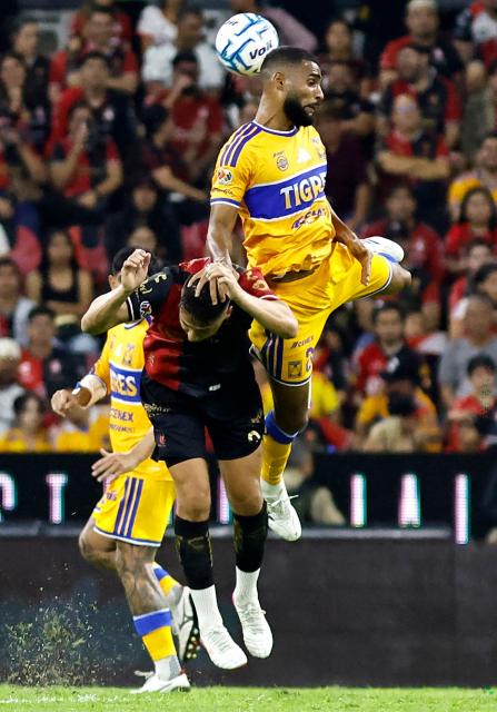Tigres' Brazilian defender #28 Joaquim Henrique (top) and Atlas' Uruguayan forward #09 Agustin Rodriguez fight for the ball during the Liga MX Apertura tournament football match between Atlas and Tigres at Jalisco stadium in Guadalajara, state of Jalisco, Mexico on August 15, 2026. (Photo by ULISES RUIZ / AFP)