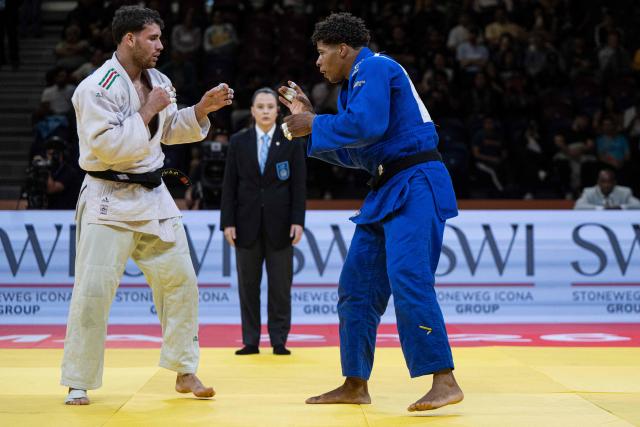 US Johan Silot (blue) competes for bronze against Italy's Vincenzo Pelligra in the men's -81kg category final event, during the International Judo Federation (IJF) Lima Grand Prix 2026, in Lima, on August 15, 2026. (Photo by Ernesto BENAVIDES / AFP)