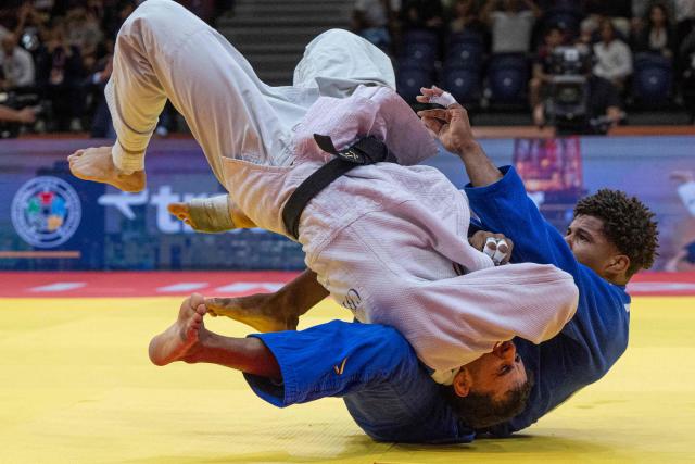 US Johan Silot (blue) competes for bronze against Italy's Vincenzo Pelligra in the men's -81kg category final event, during the International Judo Federation (IJF) Lima Grand Prix 2026, in Lima, on August 15, 2026. (Photo by Ernesto BENAVIDES / AFP)