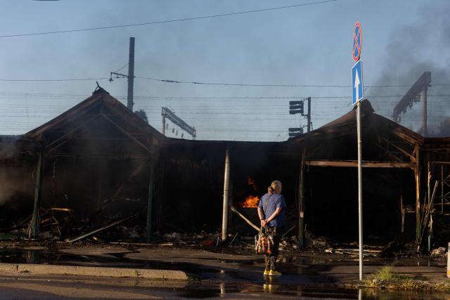 A woman stands at the site of a Russian strike in Kyiv on August 16, 2026, amid the Russian invasion of Ukraine. Russian strikes killed one person and wounded at least seven others in Ukraine, authorities said August 16, while Moscow officials reported downing more than 100 drones heading towards the capital. (Photo by Tetiana DZHAFAROVA / AFP)