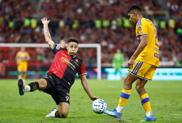 Atlas' Uruguayan forward #09 Agustin Rodriguez and Tigres' midfielder #02 Francisco Reyes fight for the ball during the Liga MX Apertura tournament football match between Atlas and Tigres at Jalisco stadium in Guadalajara, state of Jalisco, Mexico on August 15, 2026. (Photo by ULISES RUIZ / AFP)