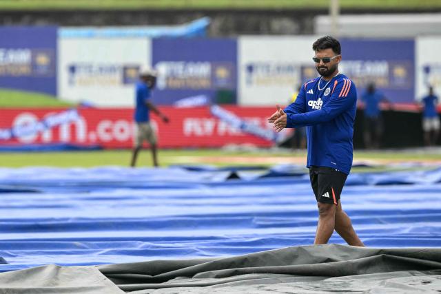 India's Rishabh Pant inspects the pitch after rain delayed the start of play on second day of the first Test cricket match between Sri Lanka and India at the Galle International Stadium in Galle on August 16, 2026. (Photo by Ishara S. KODIKARA / AFP)